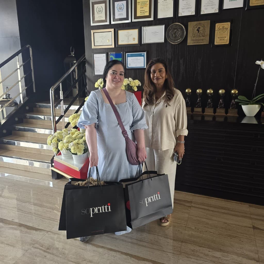 Shoppers with Sopritti bags trying jewellery at an exhibition display