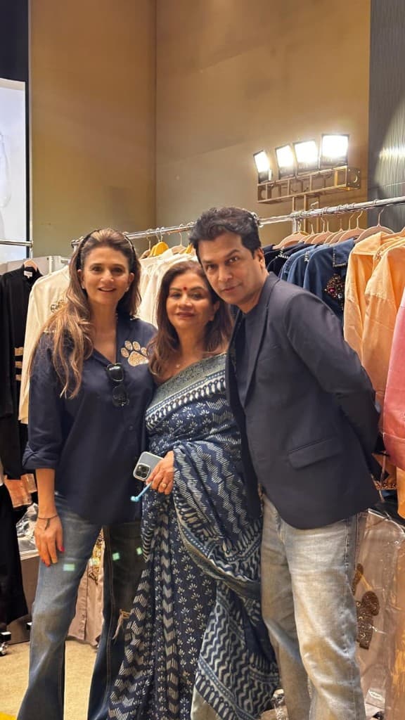 Designers and guests at a Sopritti trunk show with clothing racks and studio lighting